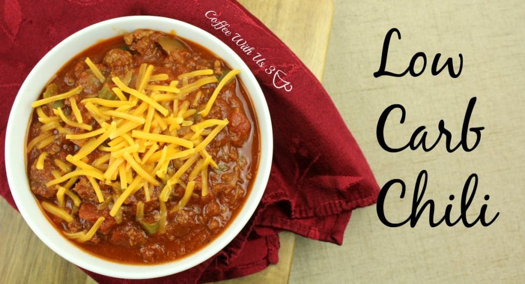 Low carb chili topped with shredded cheese. Napkin next to bow.