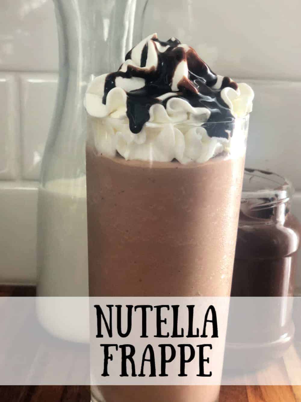 Tall glass of Nutella Frappe, topped with whipped cream and chocolate sauce.