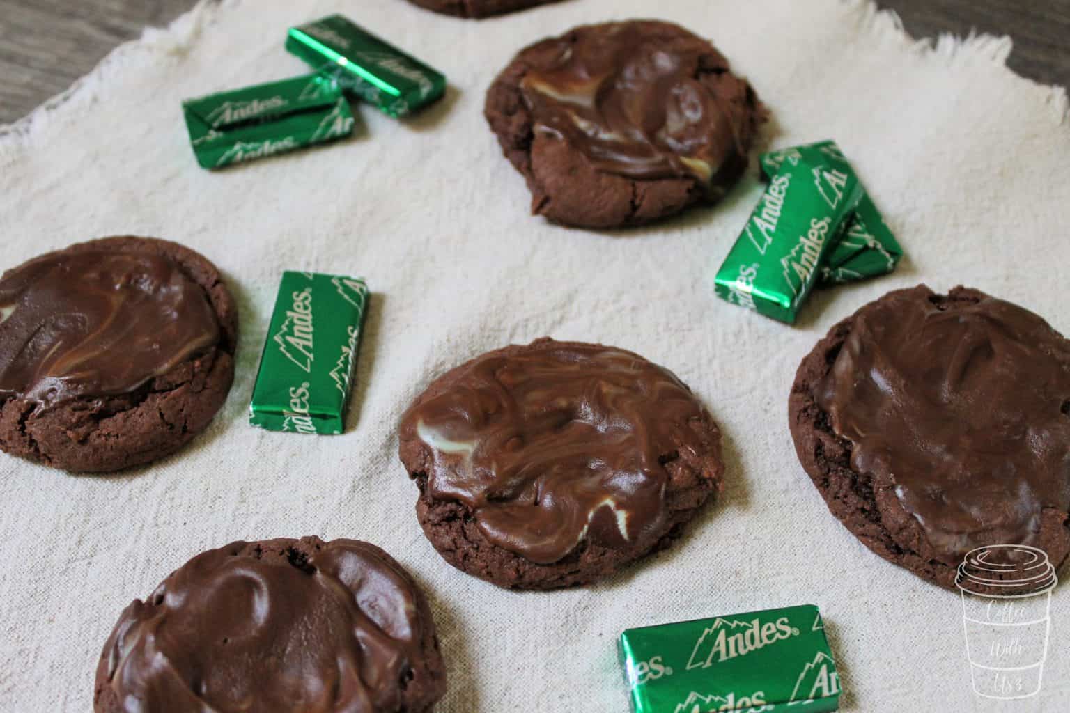 Mint Chocolate Cake Mix Cookies scattered with Andes mints on a cream placemat